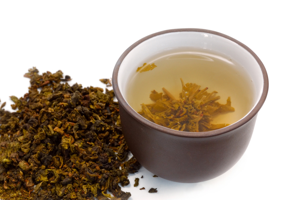 chinese cup of tea and heap of dried green tea (oolong)
